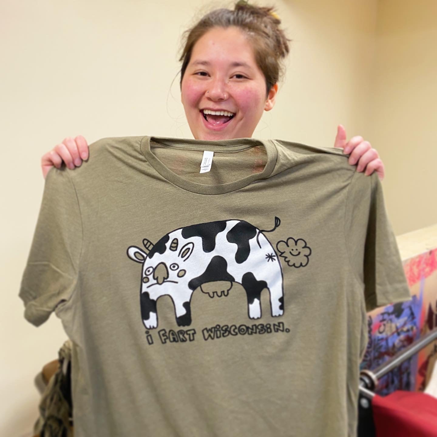 I Fart Wisconsin Farting Cow Illustration Screen Printed Tee | Assorted Colors | Heather Olive, Poppy Red, Strobe Yellow